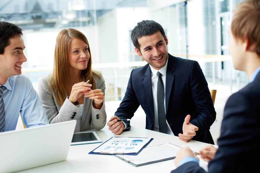 Business partners discussing documents and ideas at meeting